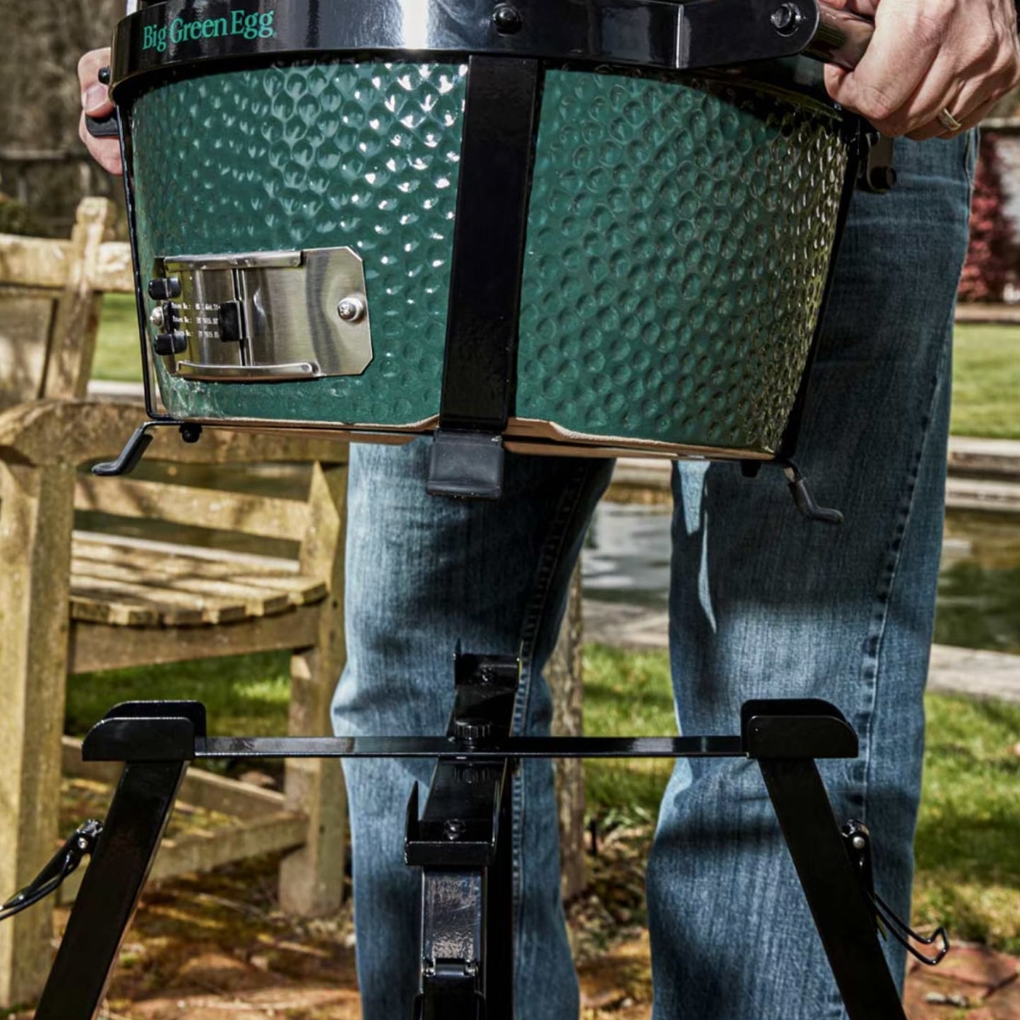 Big Green Egg Mini-Max ceramic grill and foldable, adjustable stand in a backyard cooking setup